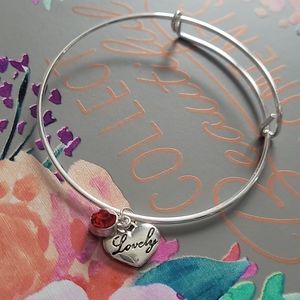 Lovely charm bangle bracelet with red gem